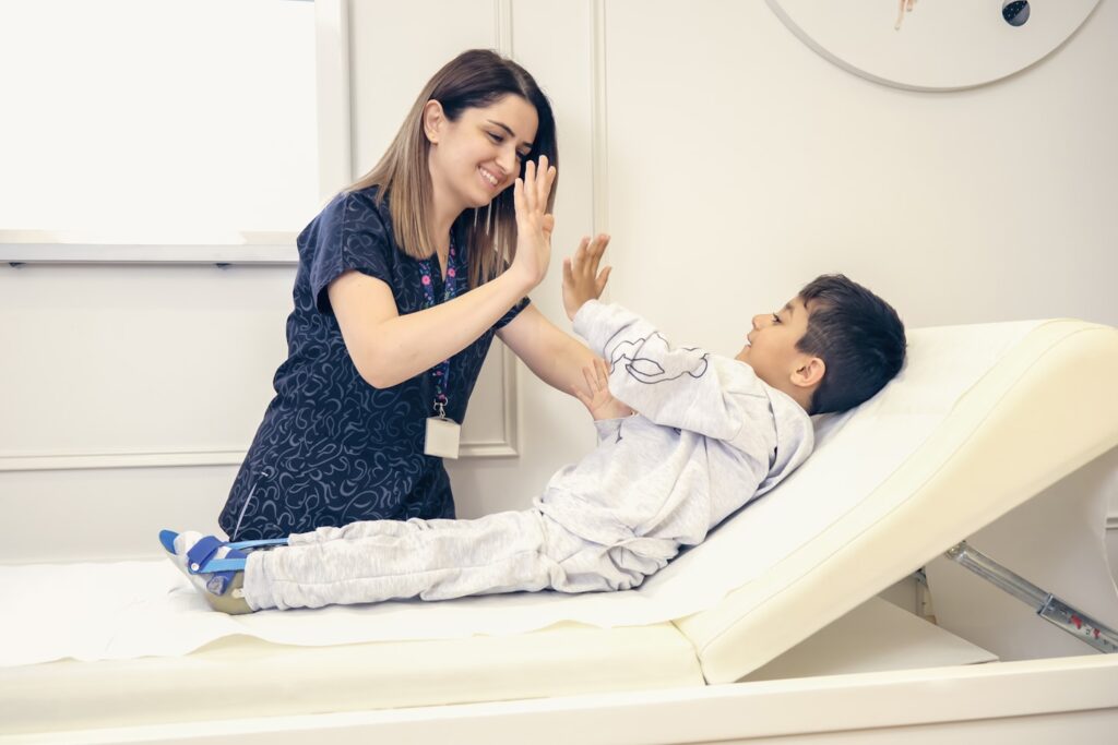 A child with osteogenesis imperfecta and a nurse together